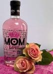bottle of MOM LOVE branded strawberry flavoured gin and pink roses