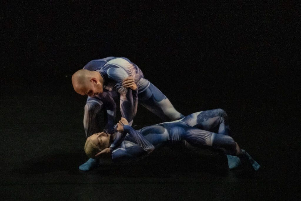 Company Wayne McGregor dancers Jordan James Bridge and Rebecca Bassett-Graham in abstract printed blue lycra catsuits. Wayne McGregor's UniVerse: A Dark Crystal Odyssey, 2023, credit Andrej Uspenski
