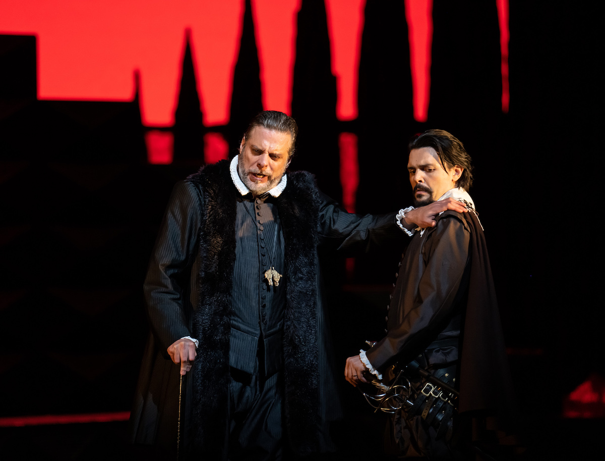 John Relyea (King Philip II) puts his hand on Luca Micheletti (Rodrigo) shoulder to confide in him. ROH Don Carlo &copy; Bill Cooper