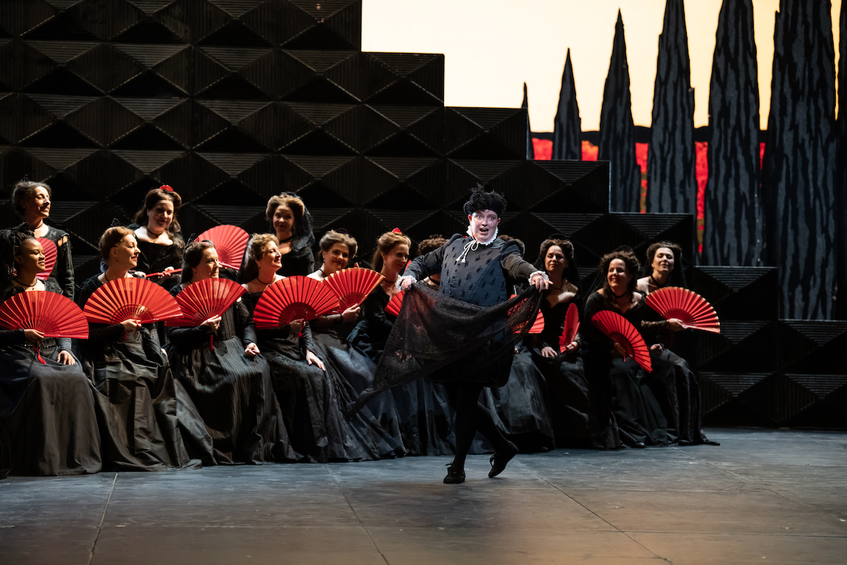 Ella Taylor (Tebaldo) dances with a shawl during a folk song. ROH Don Carlo &copy; Bill Cooper