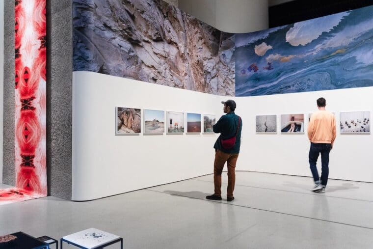 ReSisters - Man looks at a series of framed photographs