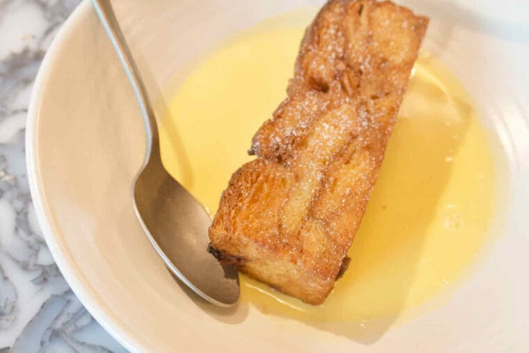 A dessert bowl of bread and butter pudding with crème Anglais custard at Duvale's Riverside East, Stratford.