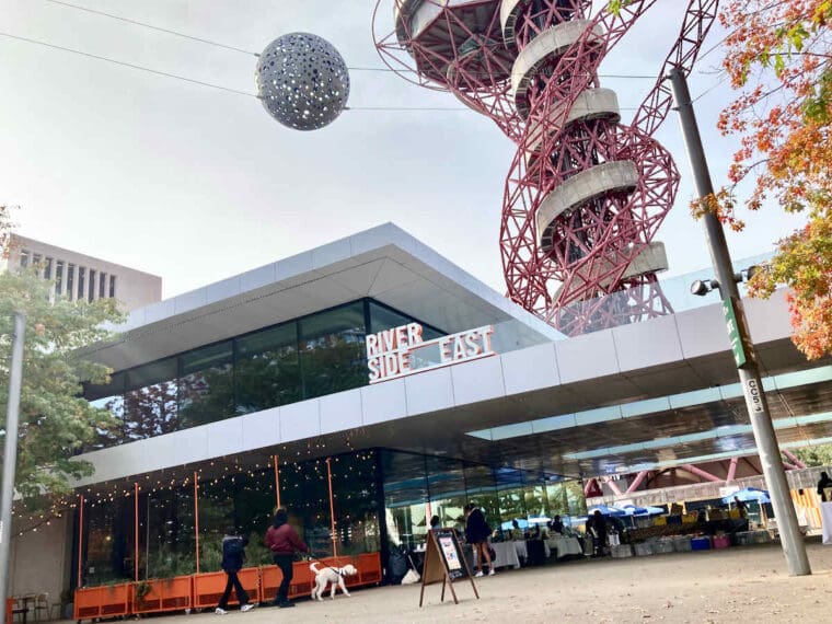 Exterior shot of Duvale's Riverside East restaurant looking up towards the ArcelorMittal sculpture tower in Queen Elizabeth Olympic Park, Stratford, East London.