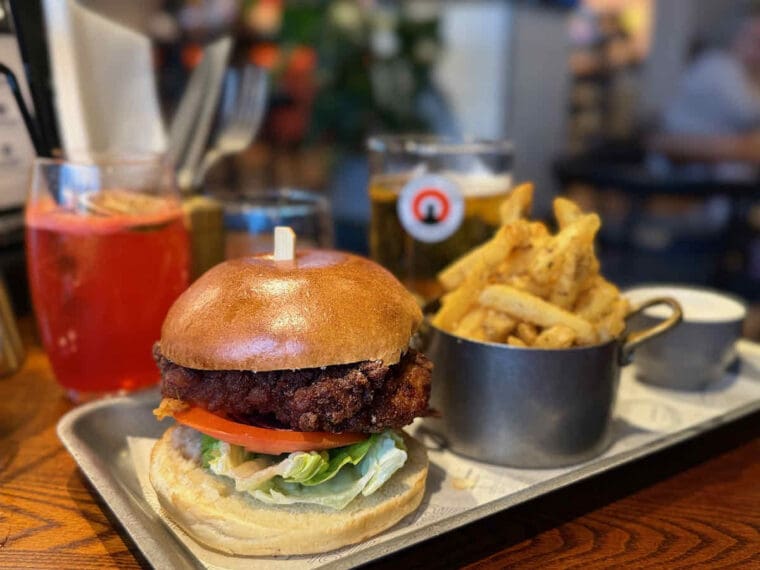 Chicken burger with fries on a metal tray served at Waterfront Street Kitchen and Bar at Royal Victoria Dock.