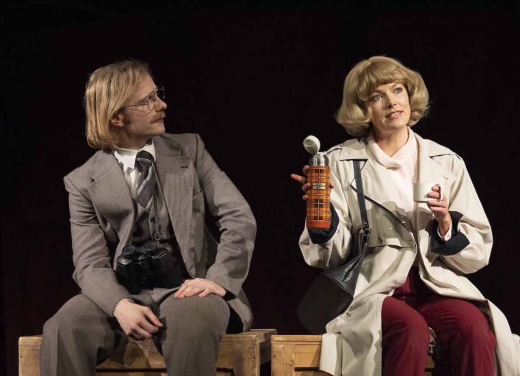Boys from the blackstuff, two actors discussing something on stage, sitting on crates