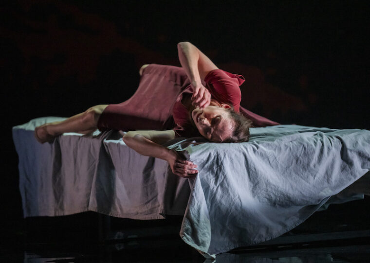 Ariadne in bed onstage in the RBO's production of Phaedra + Minotaur