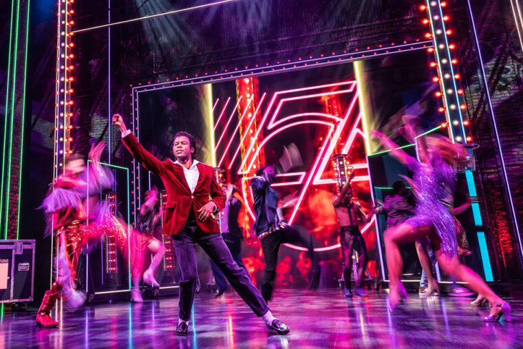 MJ The Musical Mitchell Zhangazha as young Michael Jackson on neon lit stage with dancers