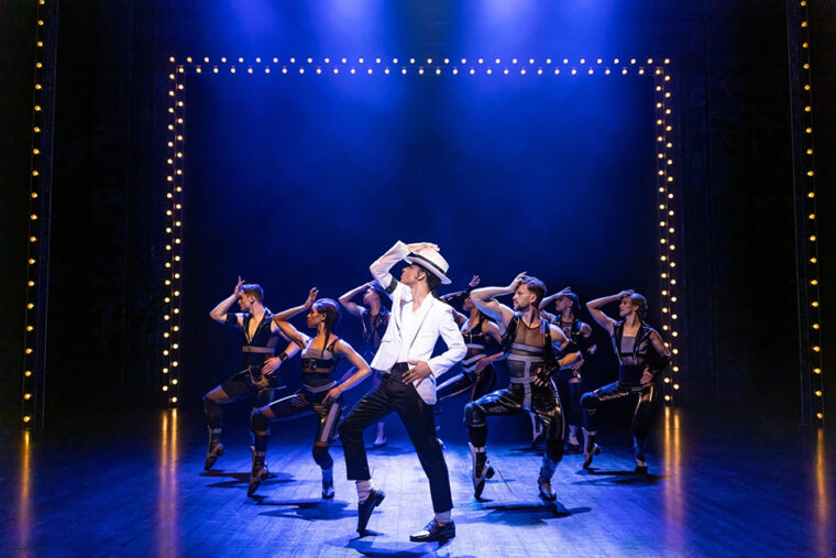 MJ The Musical Jamaal Fields-Green as Michael Jackson in black and white costume with dancers on stage