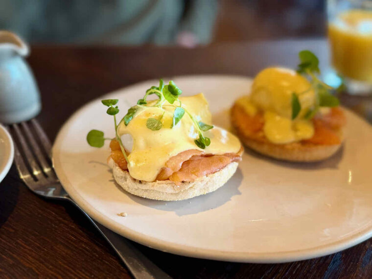 Eggs Royale breakfast served at The Royal Forest, Epping Forest; two toasted English mini muffins topped with poached eggs, smoked salmon and Hollandaise sauce. 