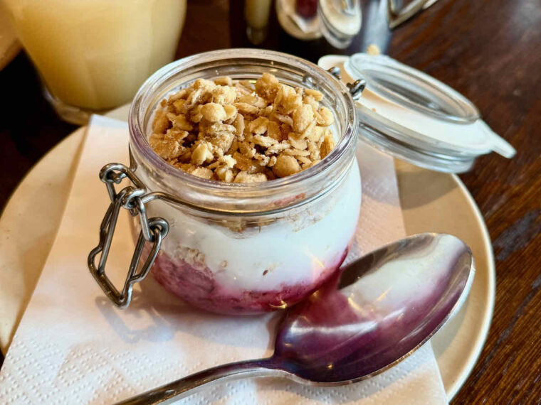 Granola, yogurt and fruit for breakfast served in a Kilner jar as seen at The Royal Forest, Epping Forest, Heartwood Inns. 