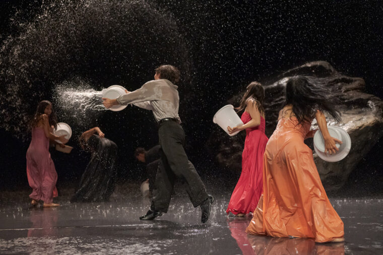 Vollmond - Tanztheater Wuppertal Pina Bausch - dancers throwing buckets of water - Image credit Martin Argyroglo