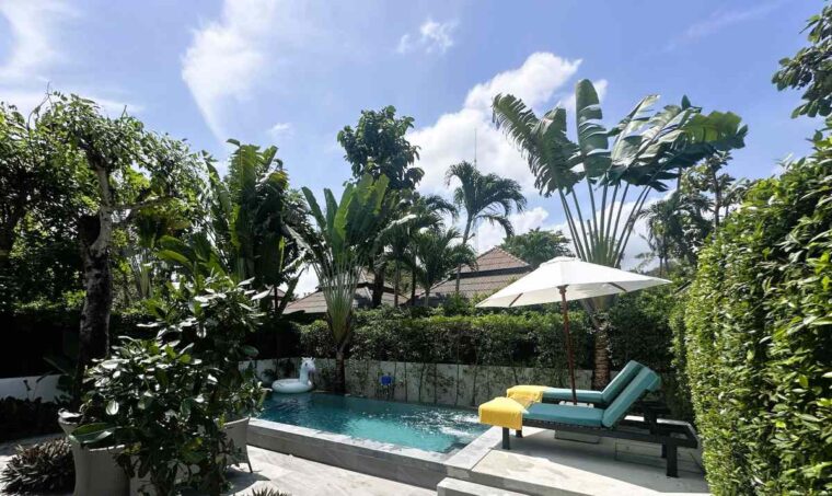 NH Collection Samui Peace Resort one bedroom pool villa has a large pool terrace with loungers and an outdoor eating area