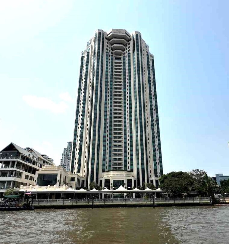 View of the iconic hotel, The Peninsula which soars above the Chao Phraya river in Bangkok