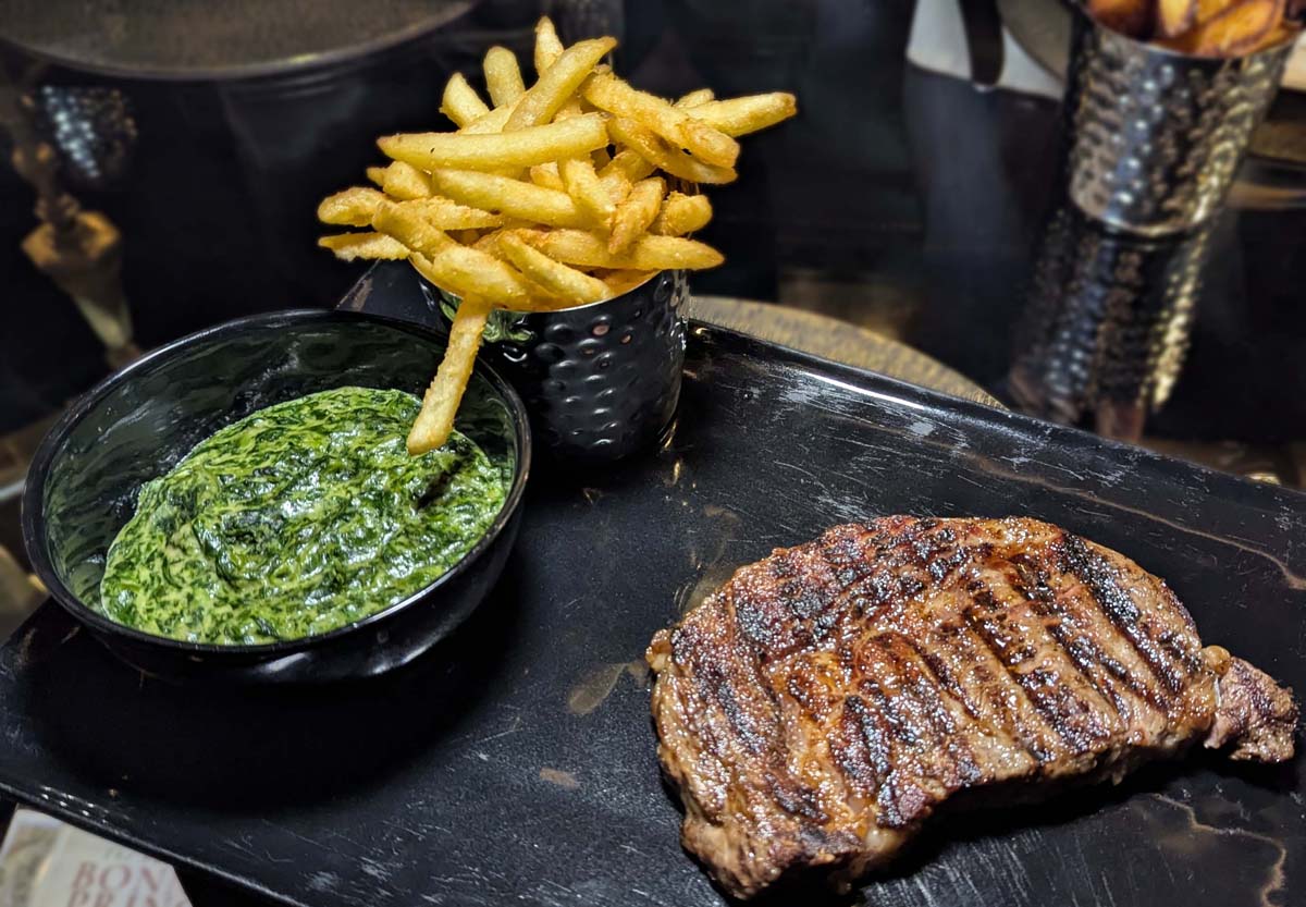 Sirloin steak with creamed spinach and fries