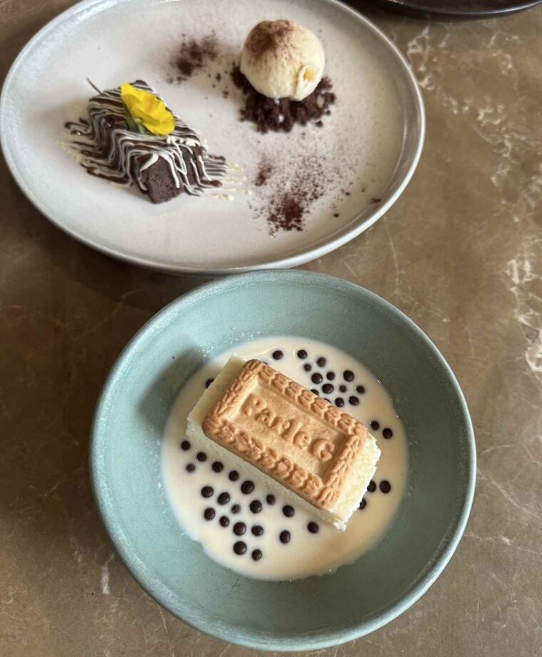 Warm spice brownie with vanilla ice cream on chocolate crumble and Parle G cheesecake at Farzi restaurant
