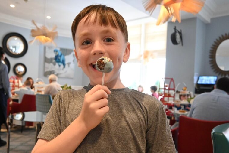 Shay eating his lolipop at Science afternoon tea experiments at The Ampersand Hotel 