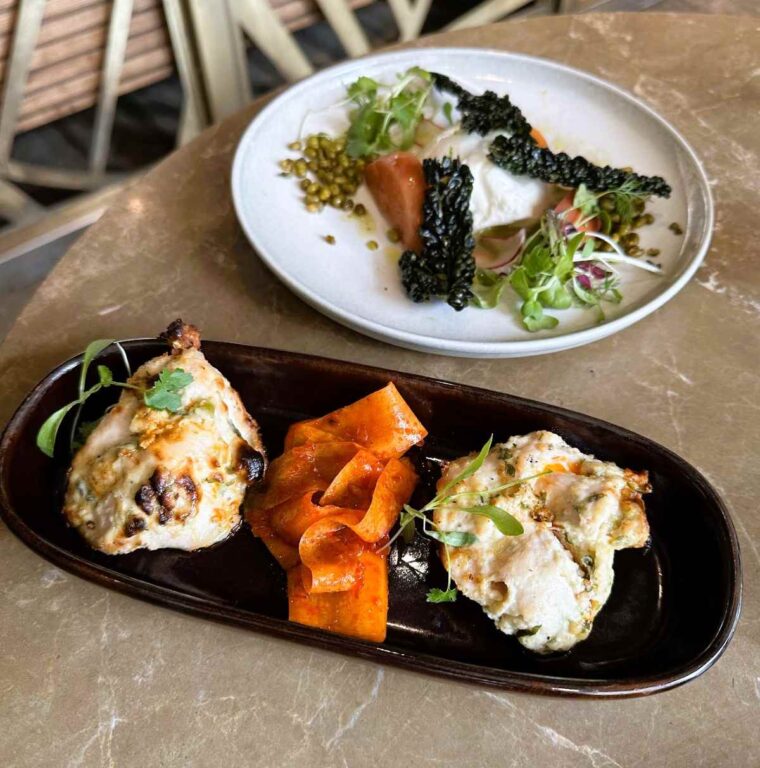 Starter dishes on pre-theatre menu at Farzi include murg malai tikka and grilled nectarine, burrata, crispy kale nero salad