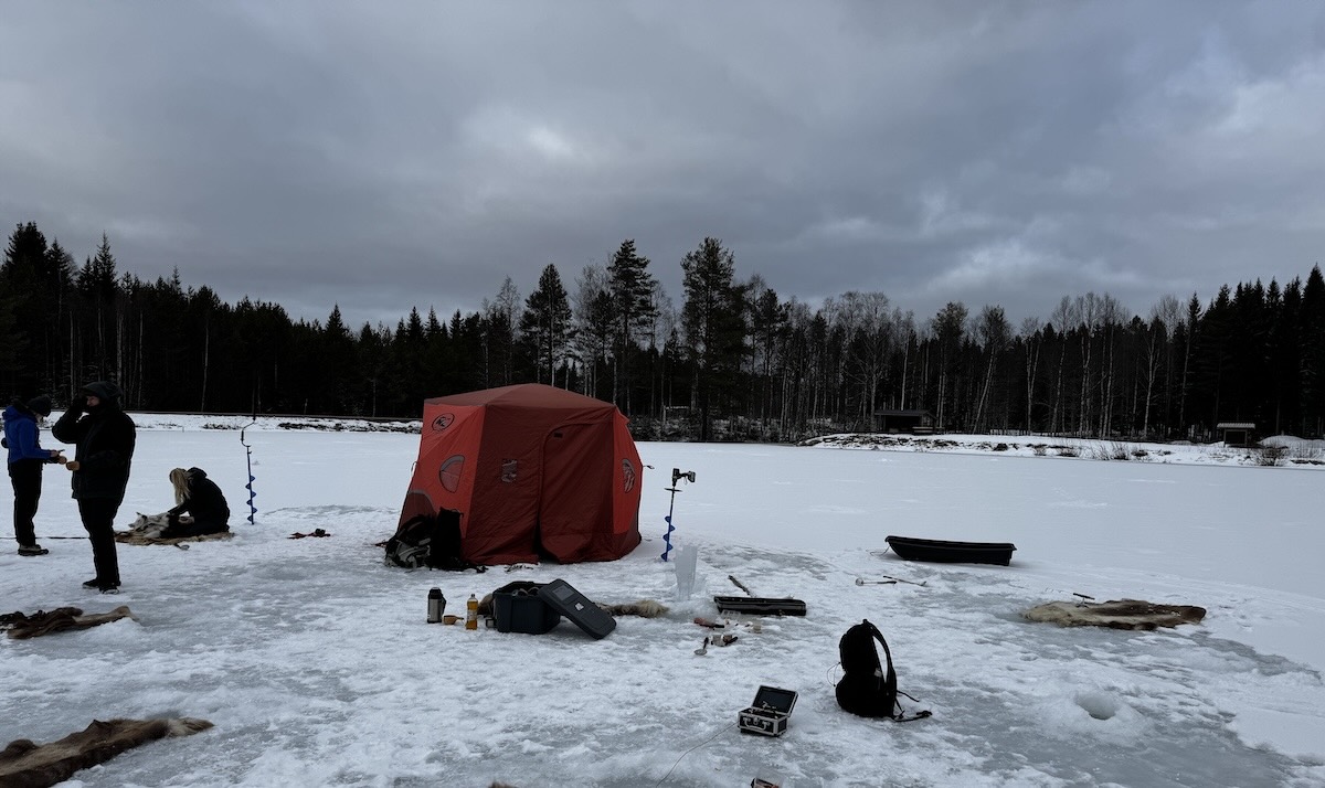 Ice hole fishing on a frozen lake 