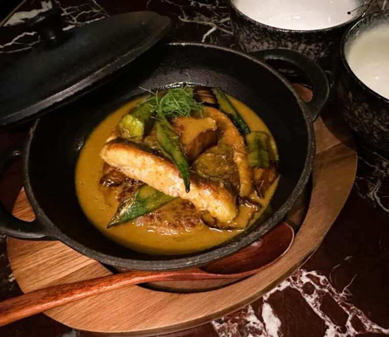 The Fuji Grill market fish 'nabe 'hotpot with yellow curry and crunchy La-Yu - with seabass, aubergine, okra and crispy rice