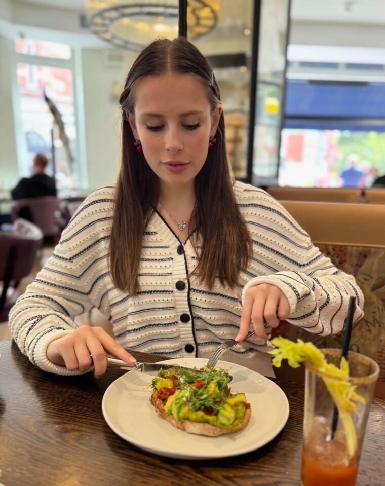 Young woman eating avocado toast.
