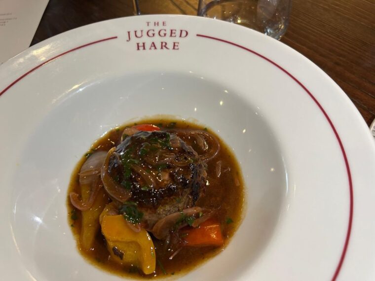 A plate of venison faggot served with a sauce of sweet and savoury house pickles.
