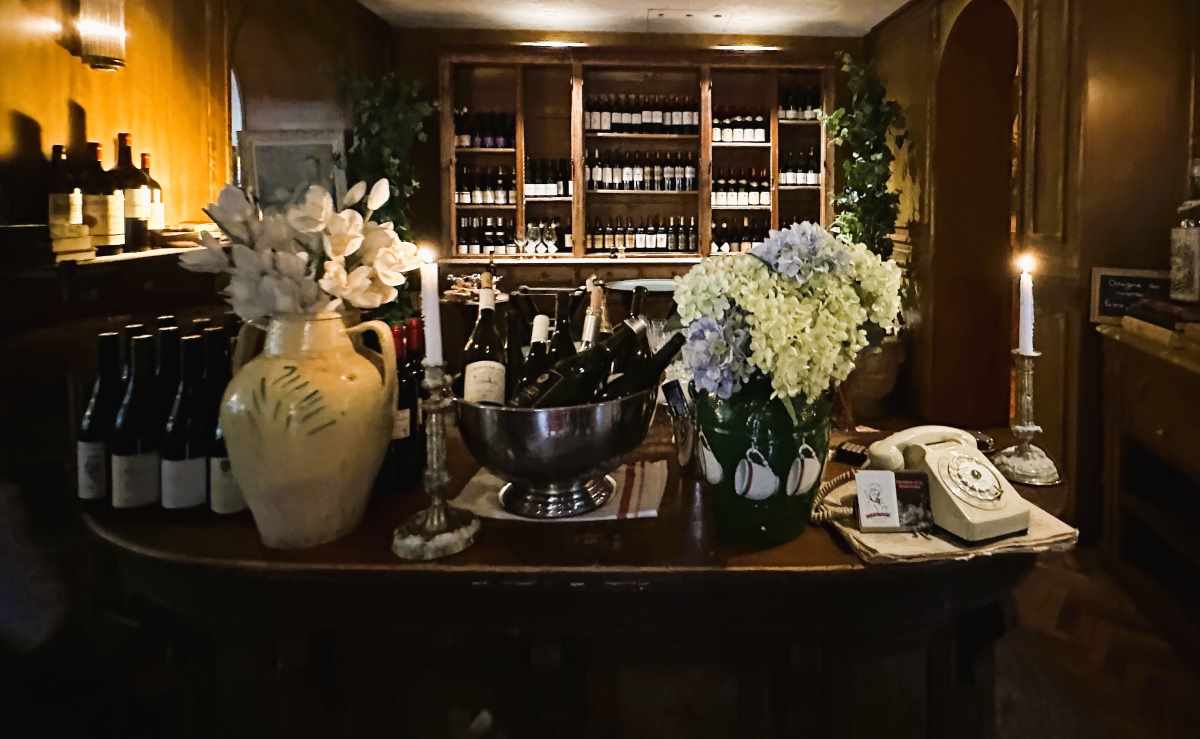 Margaux, Paris, has a wood-panelled interior and a wall of windows overlooking the street beyond.