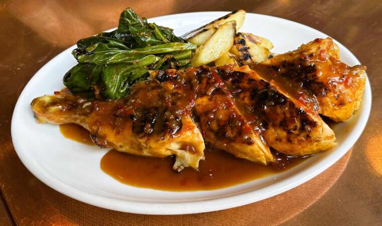 Fire and Wine corn fed chicken, sauce diable with thyme and homey parsnips and spring greens