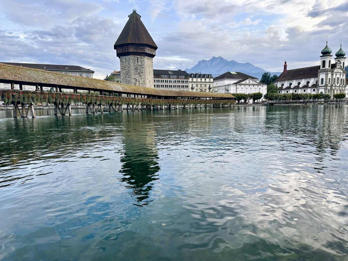 Lucerne is overlooked by Mount Pilatus. In the foreground, Chapel Bridge over the reus River