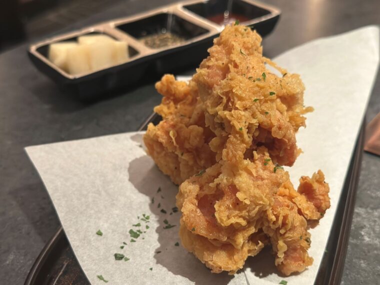 Double-fried boneless chicken thighs are served with Korean sweet-spicy sauce and garlic soy sauce at at Soom Korean BBQ