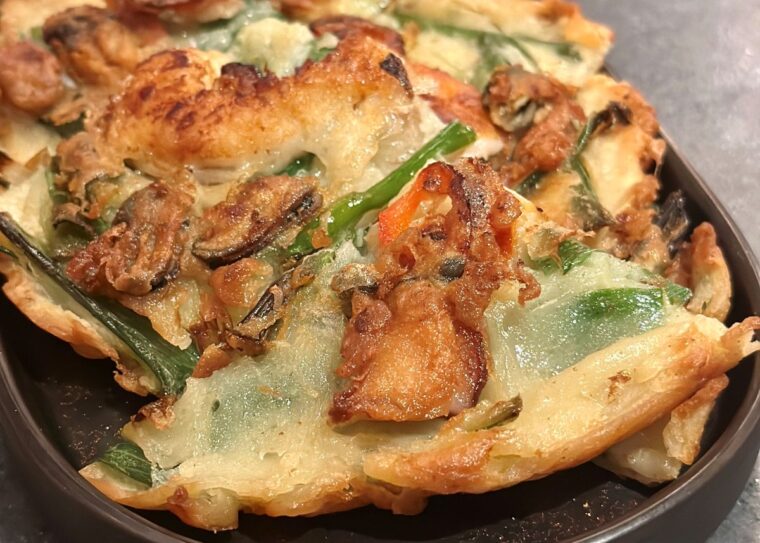Haemul Pajeon - seafood and spring onion pancake stuffed with prawns, squid, octopus and mussels. 