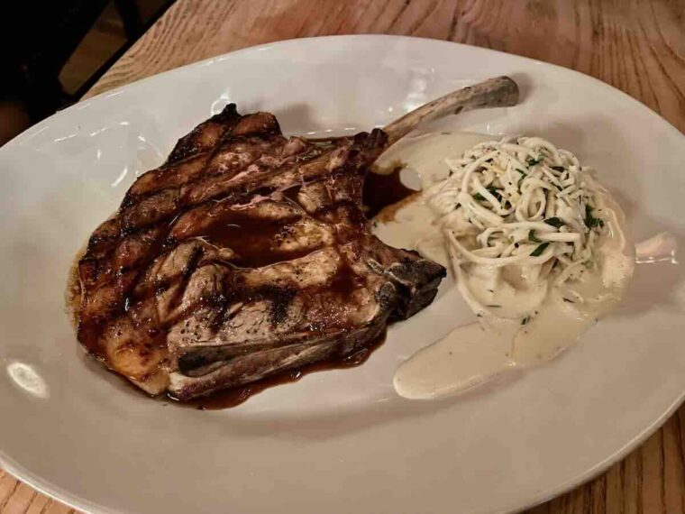Pork tomahawk with coleslaw.