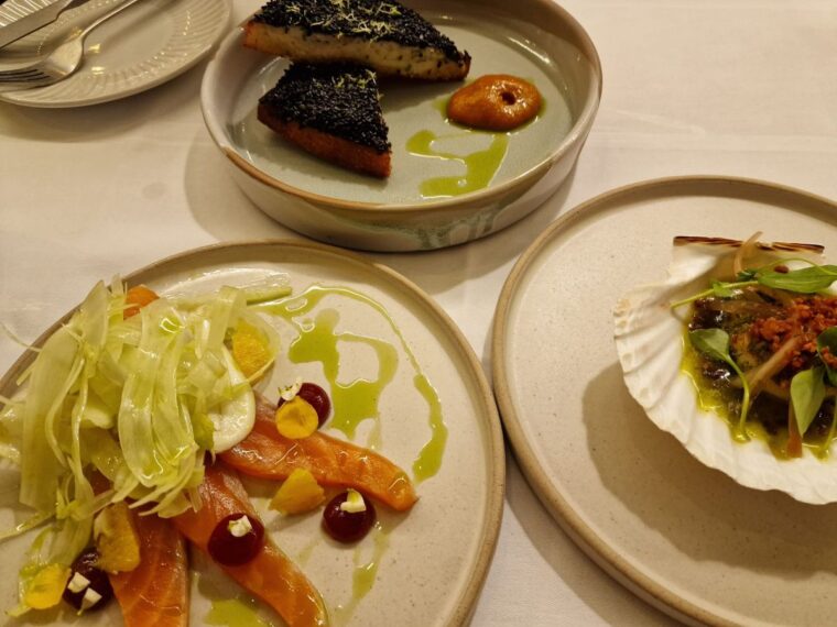 Three starter plates of cured salmon, lobster toast and a scallop at Orion by Alex Webb