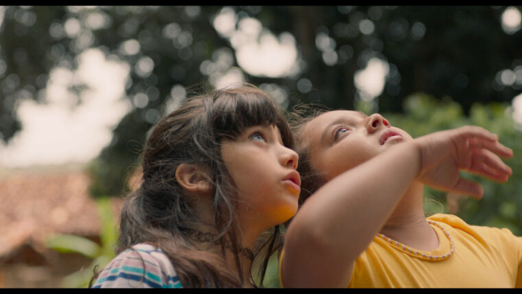 Two chldren look up at the sky in a still from the Brazilian film The Nature of Invisible Things, part of UKL/Brazil Season of Culture