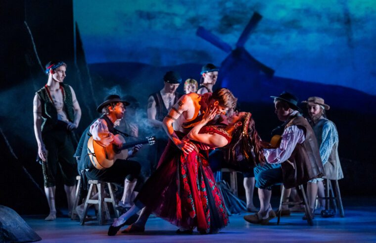 A steamy pas de deux in the gypsy camp, with live musicians and others gathered round the camp fire