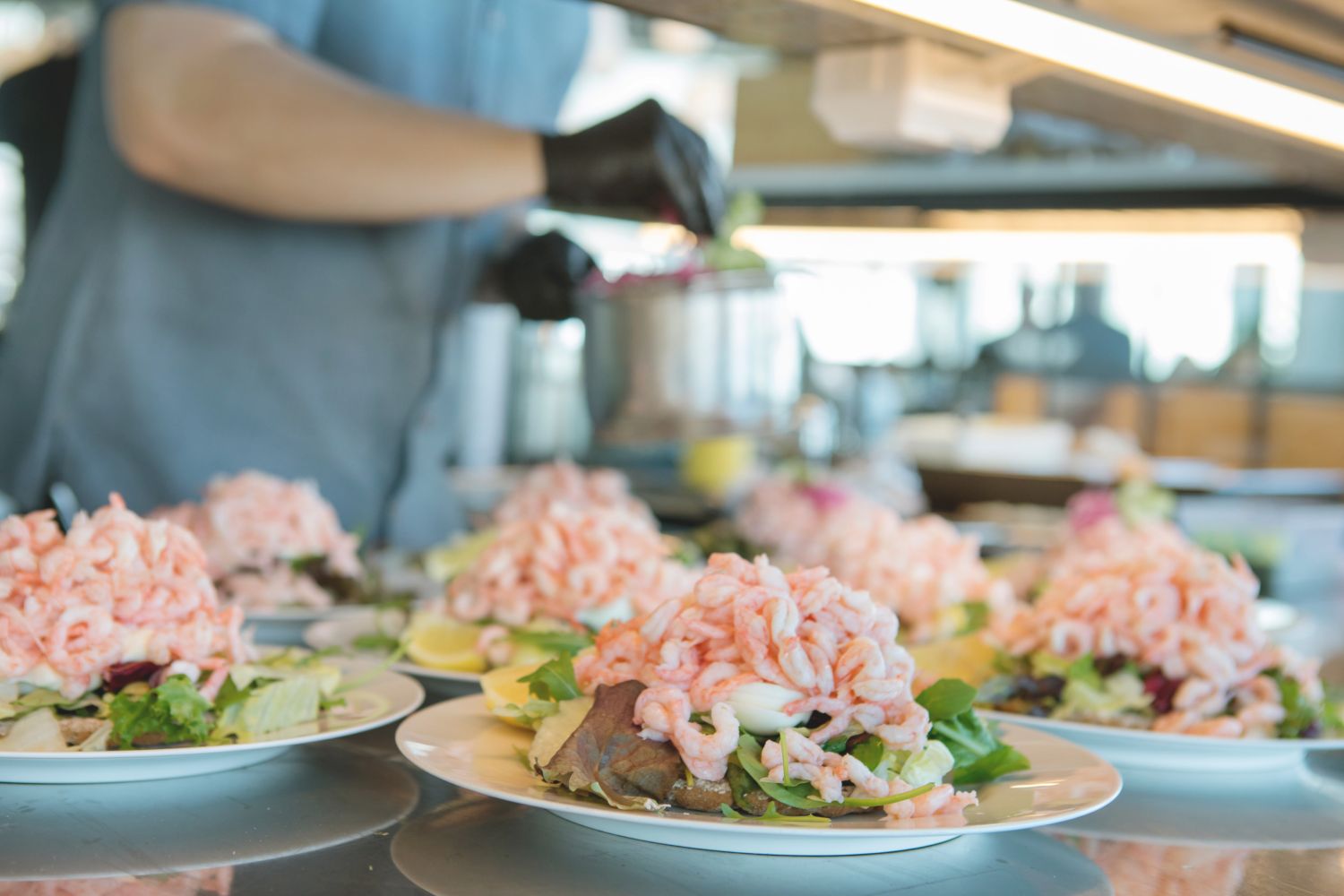 Plates of toast piled high with fresh locally sourced prawns