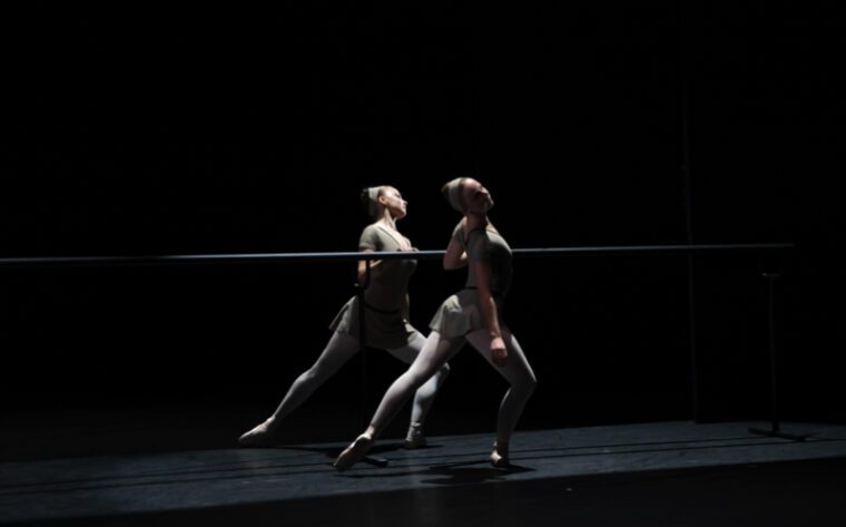 Next Generation Festival: in Cathy Marston's A Line in Reflection two female dancers mirror each other either side of a ballet barre