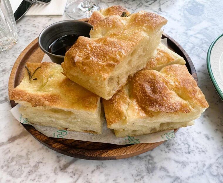 Rossella rosemary focaccia is served with balsamic vinegar and extra virgin olive oil.