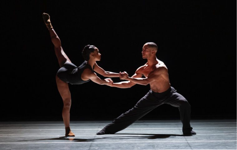 Alvin Ailey American Dance Theater, Blink of an Eye. A duet: the man to our right stands with one leg bent, supporting a woman who faces him with her left leg in a high arabesque