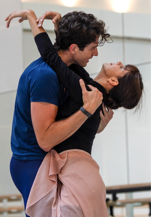 Mayara Magri and Reece Clarke in practice costumes rehearsa Manon.  He wolds her close, the leans back, all strength exhausted