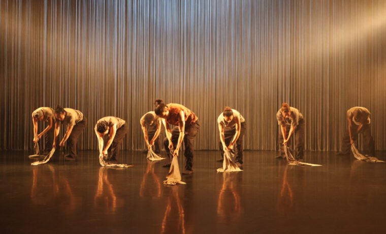 Tellus- eight dancers clutching rags hit the floor as if putting out fires