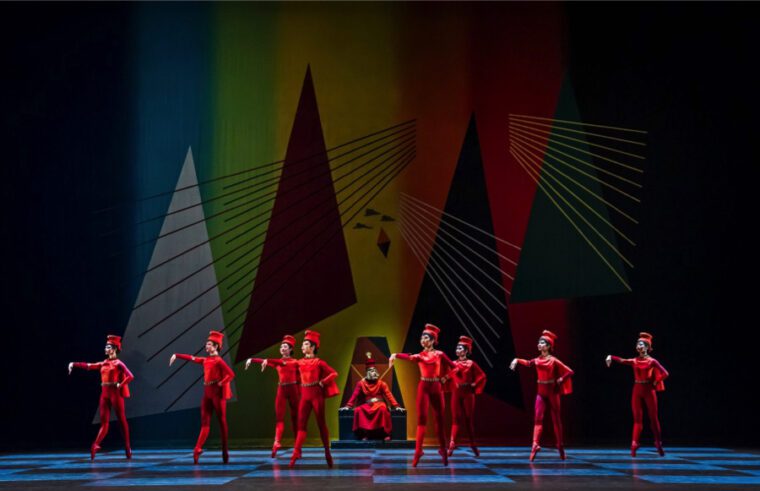 A Centenary Celebration: Against a colourful geometric backcloth, a group of young RBS students perform on pointe as Red Pawns in Ninette de Valois' Checkmate